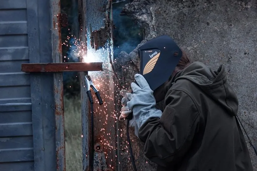 Welder performing mechanical installation works